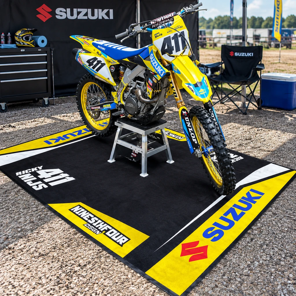 Custom printed motorcycle mat with a bike on display at a race paddock